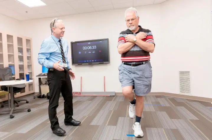 a man giving exercise instruction to another man