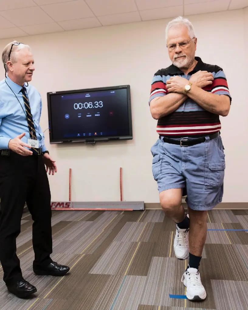 a man giving instructions to someone during exercise